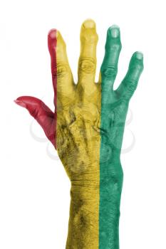 Hand of an old woman wrapped in flag of Guinea