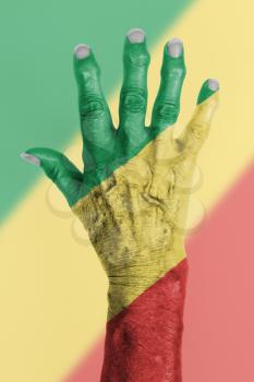 Hand of an old woman wrapped in flag of the republic of Congo