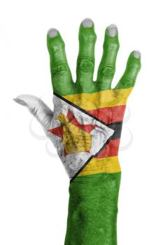 Hand of an old woman wrapped in flag of Zimbabwe