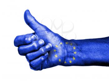 Old woman with arthritis giving the thumbs up sign, wrapped in flag pattern, European Union