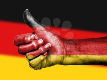German flag on thumbs up hand isolated on a flag background