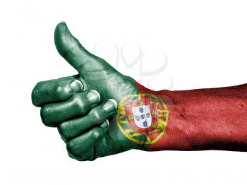 Old woman with arthritis giving the thumbs up sign, wrapped in flag pattern, Portugal
