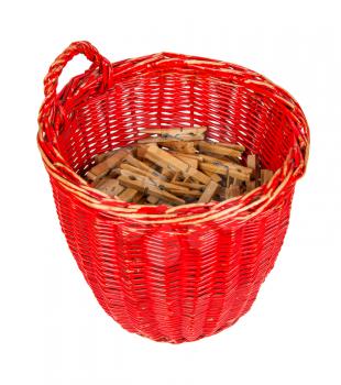Very old red basket with wooden clothespins, isolated