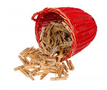 Very old red basket with wooden clothespins, isolated