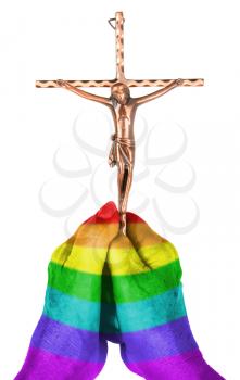Old woman holding a brass catholic crucifix, isolated on white, rainbow flag pattern