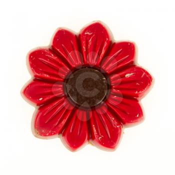 Damaged red chocolate flower, isolated on a white background
