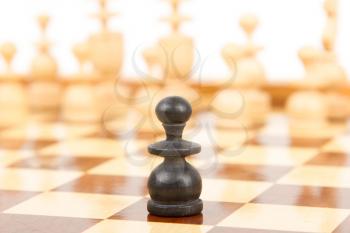 Black chess pawn isolated on a chessboard