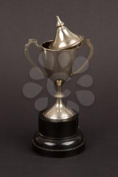 Very old trophy cup isolated on a black background