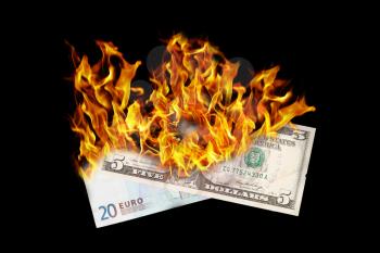 Burning money, dollar and euro bill on fire, isolated on black