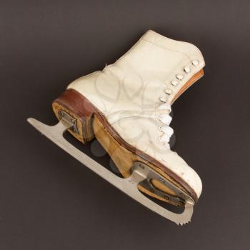 Very old figure skate, isolated on black background