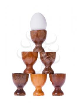 Set of different wooden egg cups isolated on white