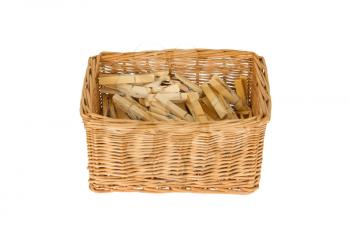 Basket with wooden clothespins, isolated on white