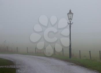 Lantern at a misty road, Ameland - Holland