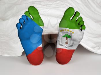 Feet with flag, sleeping or death concept, flag of Equatorial Guinea