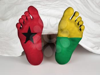 Feet with flag, sleeping or death concept, flag of Guinea-Bissau