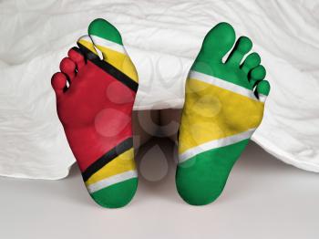 Feet with flag, sleeping or death concept, flag of Guyana