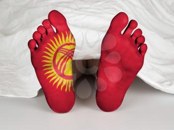 Feet with flag, sleeping or death concept, flag of Kyrgyzstan