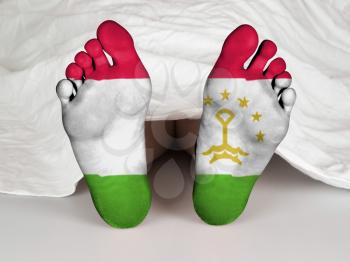 Feet with flag, sleeping or death concept, flag of Tajikistan