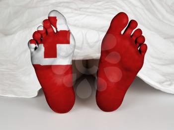 Feet with flag, sleeping or death concept, flag of Tonga