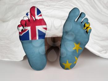 Feet with flag, sleeping or death concept, flag of Tuvalu