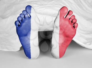 Dead body under a white sheet, flag of France