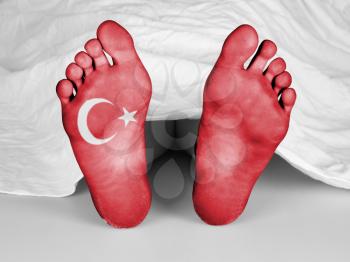 Dead body under a white sheet, flag of Turkey