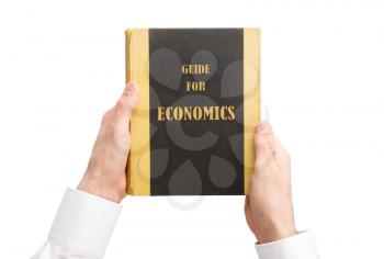 Businessman holding an old book, guide for economics
