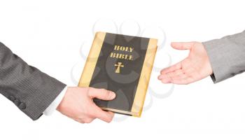 Man and woman in business suits are holding a holy bible, close-up