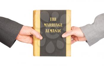 Man and woman holding a marriage almanac, saving her marriage