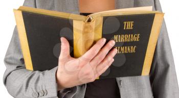 Woman reading a marriage almanac, saving her marriage