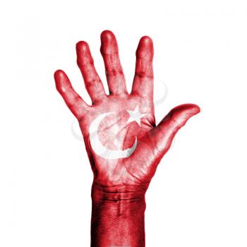 Hand of an old woman, wrapped with a pattern of the flag of Turkey, isolated on white