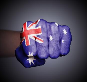 Front view of punching fist on gray background, flag of Australia
