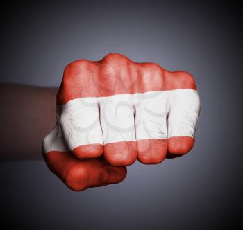 Front view of punching fist on gray background, flag of Austria
