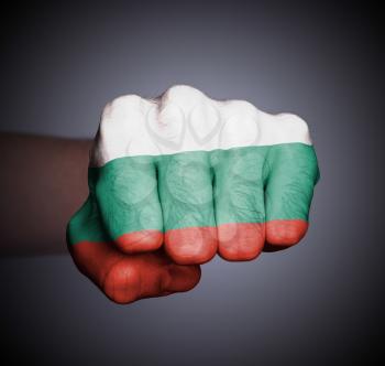 Front view of punching fist on gray background, flag of Bulgaria