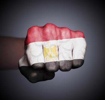 Front view of punching fist on gray background, flag of Egypt