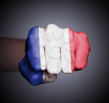 Front view of punching fist on gray background, flag of France