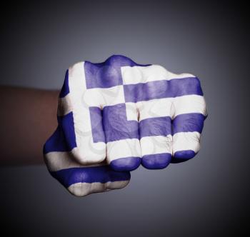 Front view of punching fist on gray background, flag of Greece