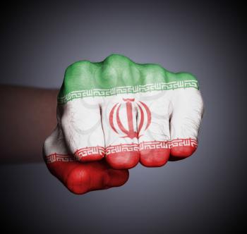 Front view of punching fist on gray background, flag of Iran