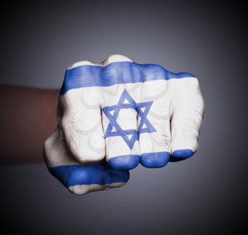 Front view of punching fist on gray background, flag of Israel