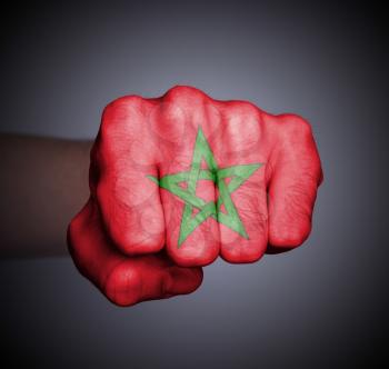 Front view of punching fist on gray background, flag of Morocco