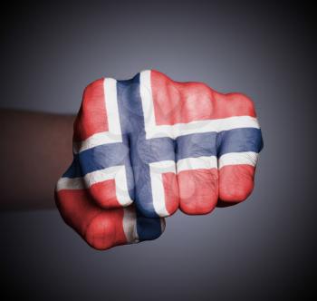 Front view of punching fist on gray background, flag of Norway