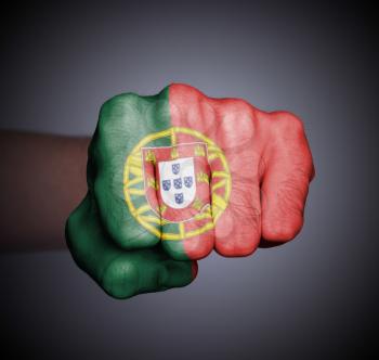 Front view of punching fist on gray background, flag of Portugal