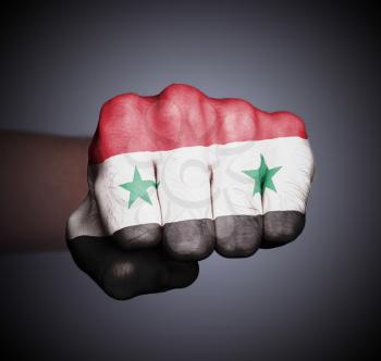 Front view of punching fist on gray background, flag of Syria
