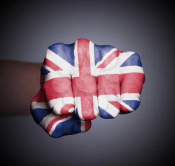 Front view of punching fist on gray background, flag of the UK