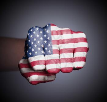 Front view of punching fist on gray background, flag of the USA