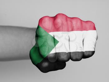 Fist of a man punching, flag of Sudan