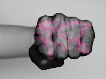 Very hairy knuckles from the fist of a man punching, world map neon print