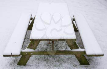Picknick table covered in snow, winter in Holland
