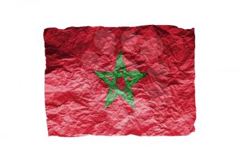 Close up of a curled paper on white background, print of the flag of Morocco