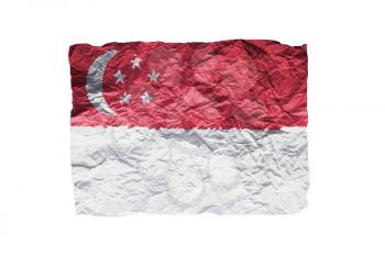 Close up of a curled paper on white background, print of the flag of Singapore